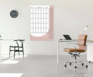 A pink office with a Repositionable Dry Erase Calendar For Wall.