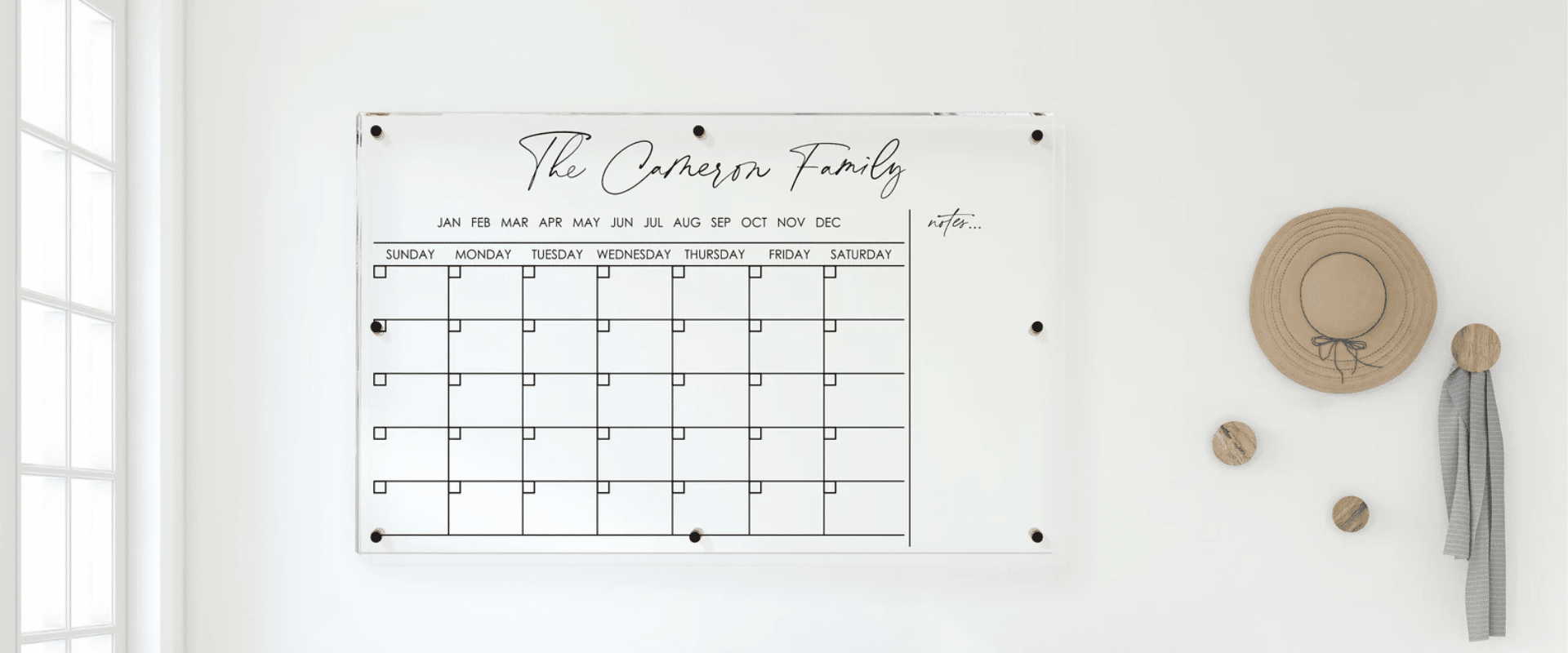 A personalized acrylic calendar for wall adorned with a hat.
