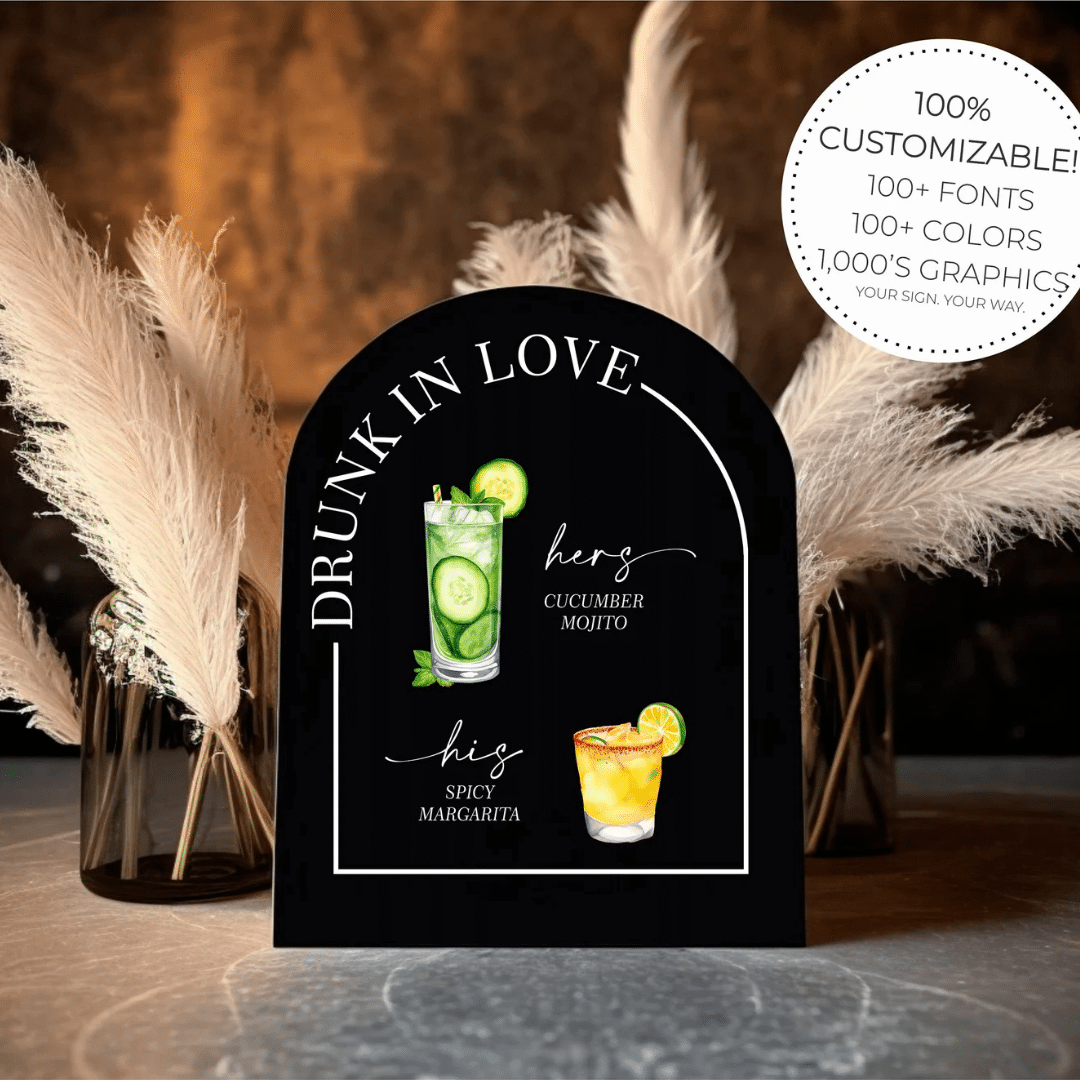 A drink in love sign on a table with feathers.