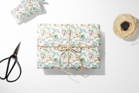 Bunny and Floral Wrapping Paper and scissors on a white surface.