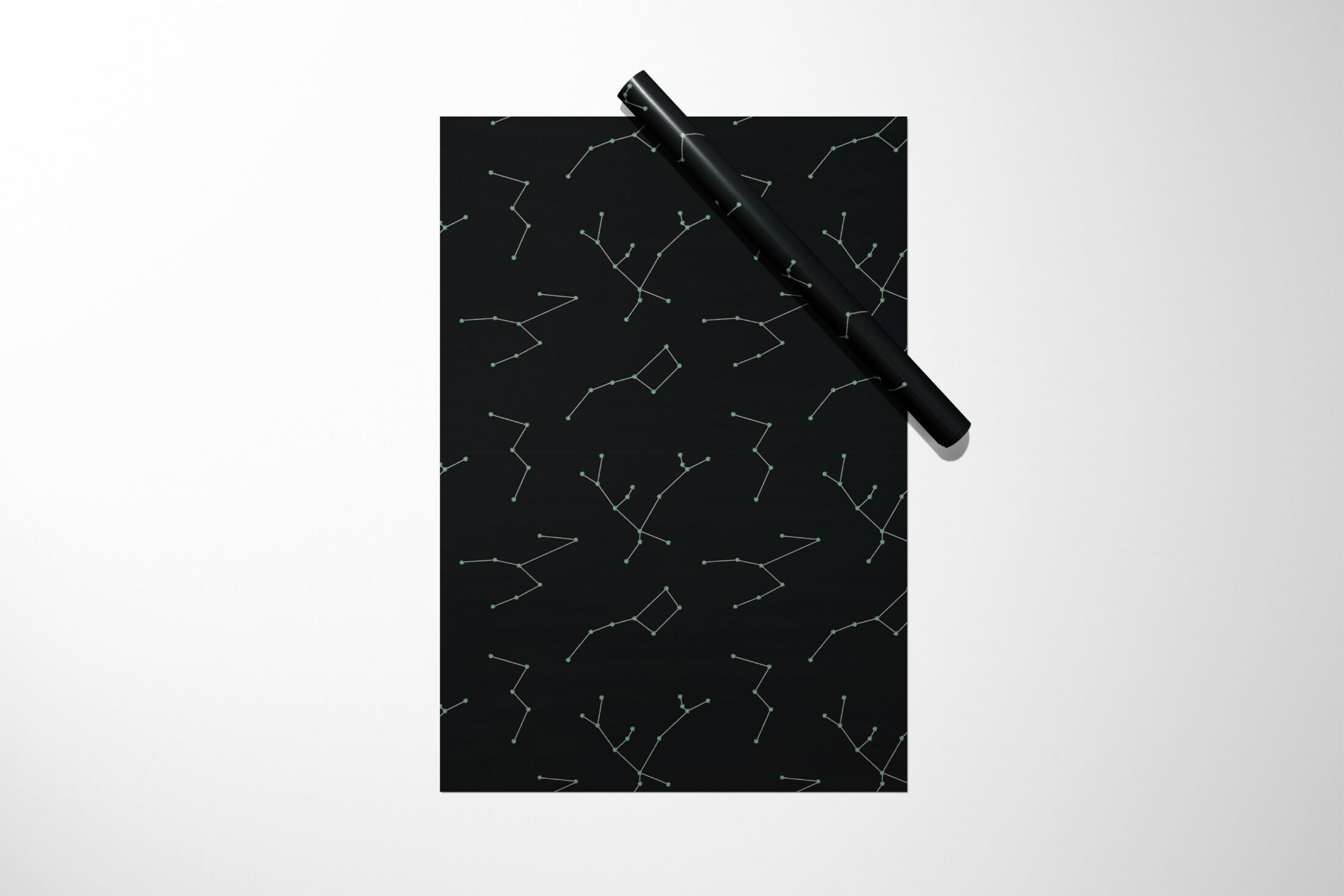 A black notebook with Constellation Wrapping Paper on it, perfect for gift wrapping or as a unique Christmas present.