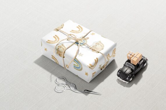 A gift box with scissors and a car next to it, wrapped in Decorative Bunny Wrapping Paper.