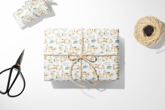A Bunny and Floral Wrapping Paper with a bow and scissors next to it.