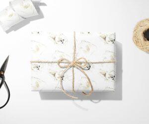 A Maltese Dog Wrapping Paper with a bow and scissors next to it, perfect for a unique gift.