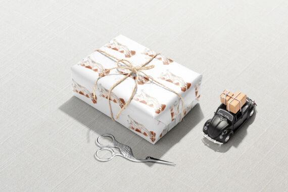 A gift wrap with scissors and a Brittany Spaniel Wrapping Paper next to it.