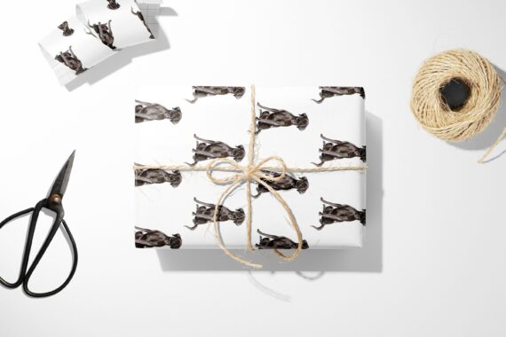 A Christmas wrapping paper featuring a Black Labrador Retriever.