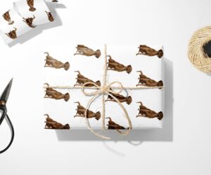 A Chocolate Labrador Retriever Wrapping Paper in Christmas wrapping paper with scissors.