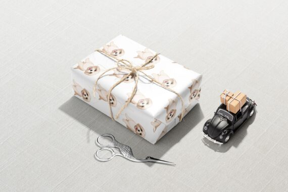 A gift box with a Shih Tzu Dog Wrapping Paper on it and scissors.