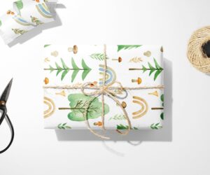 A unique Boho Forest Rainbow Wrapping Paper with scissors and Christmas Wrapping Paper next to it.