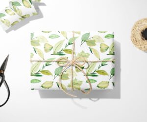 A Green Leaves Wrapping Paper with scissors next to it.