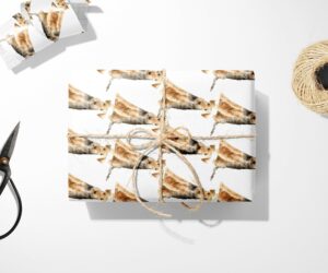 A Welsh Terrier Dog Wrapping Paper with a Christmas tree next to it.