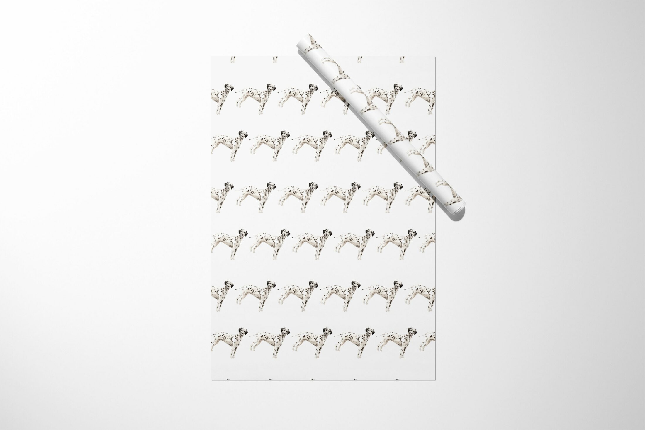 Christmas wrapping paper featuring a stylish black and white Dalmatian dog pattern.