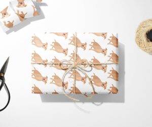 A white Christmas wrapping paper with a Brown Pitbull dog on it.