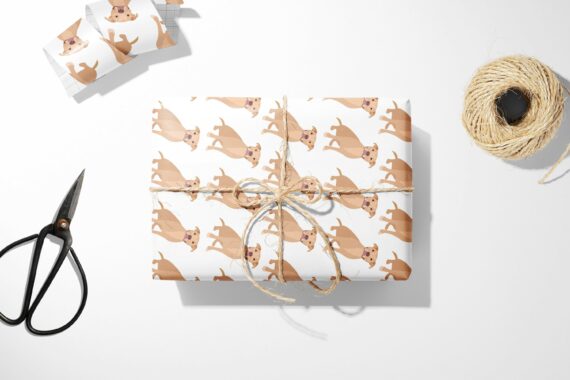 A white Christmas wrapping paper with a Brown Pitbull dog on it.