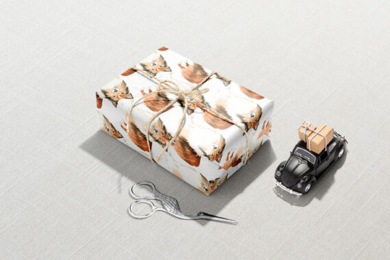 A Shetland Sheepdog Wrapping Paper with a pair of scissors next to it.
