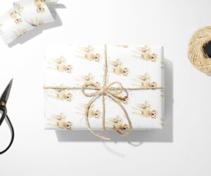 A wrapped present with Goldendoodle Dog Wrapping Paper design on Christmas wrapping paper.