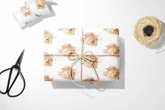 A Pomeranian Dog Wrapping Paper and scissors on a white surface, ready for gift-wrapping.